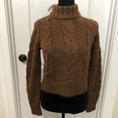 American Eagle Outfitters Brown Cable Knit Turtleneck Sweater Us Size Small Nwt Stay Warm And Stylish With This American Eagle Turtleneck Sweater. Features A Classic Cable Knit Design In A Rich Brown Color. Cable Knit Design Turtleneck Style Brown Color Made With Recycled Polyester & Wool Long Sleeves Condition: Nwt Brand: American Eagle Color: Brown Size: Small Measurements Laying Flat (Approximate): Sleeve: 24 Inches Length: 21 Inches Chest (Pit To Pit): 18 Inches Shoulder To Shoulder: 14.5 In American Eagle Sweaters, Brown Cable Knit Sweater, Brown Turtleneck Sweater, Brown Turtleneck, Cable Knit Turtleneck, Brown Knit Sweater, Turtleneck Style, Cable Knit Turtleneck Sweater, Knit Turtleneck