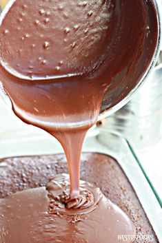 melted chocolate being poured into a pan with other items in the backgroung