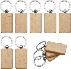 six wooden keychains with metal rings and one wood block on each side, all in different shapes and sizes