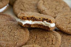 some cookies with cream filling are on a plate