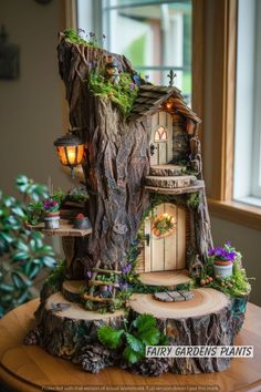 a fairy garden house made out of tree stumps with lights and plants on top