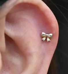 a close up of a person's ear with a bow on it