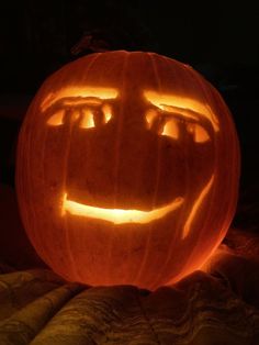 a carved pumpkin with glowing eyes and mouth