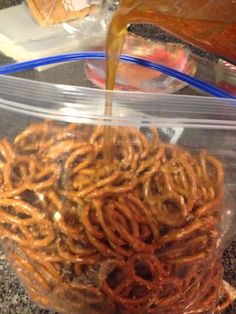 a plastic container filled with pretzels sitting on top of a counter