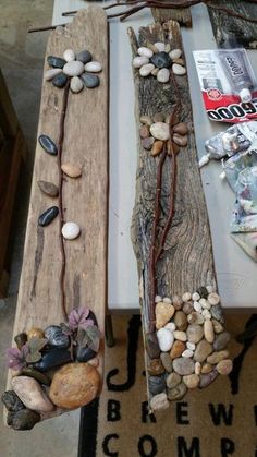 two pieces of driftwood are sitting on the ground next to each other, with rocks and stones embedded in them