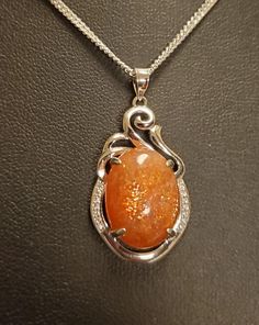 "Sparkling Natural Sunstone Necklace, 13x17mm Orange Schiller Stone, 925 Sterling Silver Swirl Top Pendant With Tiny Cubic Zirconia Trim. 20\" Sterling Chain. Chain Length Options Available By Messaging Seller At Time Of Purchase. Gift Box Included." Sunstone Necklace Pendants, Orange Gem Necklace, Gem Necklace Stones, Aries Moodboard, Genshin Modern, Opals Jewelry, Rocks Jewelry, Jewel Pendant Necklace, Sunstone Necklace