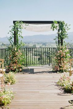 an outdoor ceremony setup with chairs and flowers