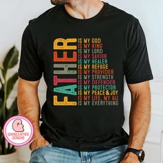 a man wearing a black t - shirt with the words faith in different colors on it