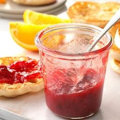 a jar filled with jam next to some lemon slices