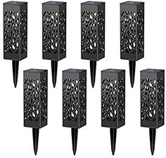 six black metal candle holders with holes on each one side and an open design in the middle