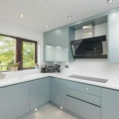 a kitchen with blue cabinets and white counter tops