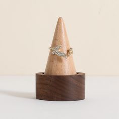 a small wooden cone with a ring on top