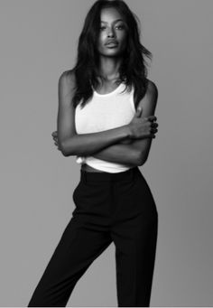 a black and white photo of a woman with her arms crossed