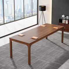 a wooden table sitting on top of a carpeted floor next to a large window