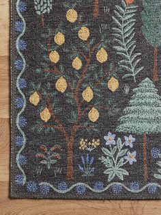 a rug with trees and flowers on it