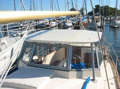 there is a small boat that is docked at the dock with other boats in the water