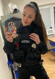 a police officer is holding up her cell phone