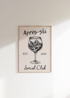 a sign on the wall that says aprrez ski social club with a glass of wine in it