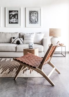 a living room filled with furniture and pictures on the wall above it's coffee table