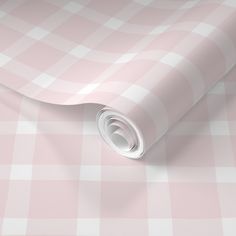 a pink and white checkered wallpaper with a rolled up roll on it's side