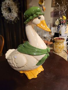 a ceramic duck sitting on top of a wooden table