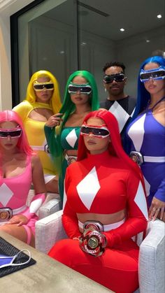 several people in costumes are sitting on a couch and posing for a photo with their computer