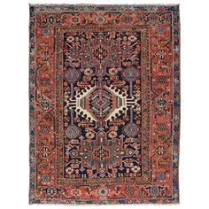 an antique persian rug with blue, red and orange colors on the border is shown