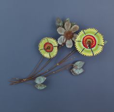 three paper plates with flowers and leaves on them