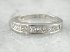 a white gold wedding band with princess cut diamonds