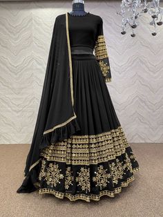 Bollywood Replica LehengaFaux georgette lehenga and choli with 5mm sequence embroidery work.Semi stitch lehenga and unstitch blouse material .Dupatta in faux georgette with ruffles work with four side lace border.Shipping time 5-7 daysBuy this Saree at Kollybollyethnics and make your occasion very special !!. With Express Free Shipping and Custom Stitching, Shop Bollywood Model Black georgette wedding lehenga at kollybollyethnics from India with free worldwide shipping. Luxury Party Wear Choli With Dabka Work, Luxury Choli With Zari Weaving For Eid, Luxury Black Lehenga With Dabka Work, Luxury Black Lehenga With Cutdana, Luxury Georgette Choli With Tiered Skirt, Luxury Black Lehenga For Navratri, Elegant Cheap Choli With Zari Work, Luxury Festive Choli In Maxi Length, Cheap Semi-stitched Bollywood Choli