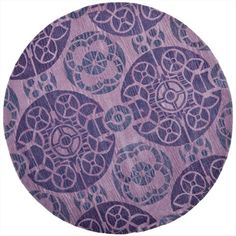 a circular rug with an intricate design in purple and blue on the bottom, surrounded by circles