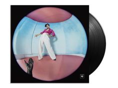 an album cover with a woman in white pants and pink shirt standing on top of a ball