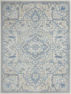 a blue and white rug with an intricate design