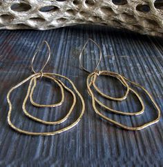 "Artisan handmade organic shape earrings. Each component is hand shaped so each will have it's own unique shape. The Details ∞ Artisan handmade jewelry ∞ 14k gold filled handmade textured drops ∞ 14k gold filled handmade ear hooks ∞ Approximate total length ~ 3\" ∞ Made to order Θ Allow up to 14 business days before shipment Θ ∞ Gift box included ∞ Made in the USA Pick up a matching pendant necklace here... https://www.etsy.com/listing/641990023/gold-boho-statement-necklace-large VISIT OUR SHOP: Minimalist Freeform Sterling Silver Jewelry, Modern Freeform Gold Jewelry, Artsy Gold Drop Earrings, Gold Artsy Drop Earrings, Artisan Freeform Gold Jewelry, Hand Forged Freeform Elegant Jewelry, Hammered Freeform Jewelry As A Gift, Hammered Freeform Jewelry For Gifts, Artsy Gold Brass Jewelry