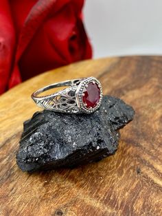 Natural Red Ruby Ring  New Vic Design#11 This is a stunning Edwardian/Victorian estate reproduction in sterling silver filigree with a natural 1.38ctw ruby gemstone. The red ruby is 8mm in diameter. The inside of the band is marked 925 for sterling. The natural ruby is heat and color treated, quality i1-i3.  Notice the beautiful craftsmanship of the silver filigree setting and band. This is an ornate and detailed ring. This is a lovely rendition of an antique filigree ring, and it is ready to we Heirloom Red Filigree Ring, Antique Ruby Filigree Ring, Red Victorian Filigree Ring With Gemstone, Red Ruby Filigree Ring, Classic Red Ruby Ring With Filigree, Classic Red Ruby Ring With Intricate Design, Red Hallmarked Filigree Ring, Ornate Round Ruby Ring, Hallmarked Red Filigree Ring