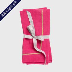 pink napkins with white ribbon and gold trim