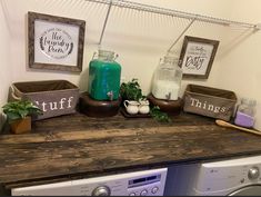 there is a washer and dryer in the room with signs on the shelf