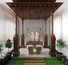 an indoor shrine with statues and potted plants on the ground in front of it