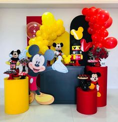 a mickey mouse party with balloons and decorations