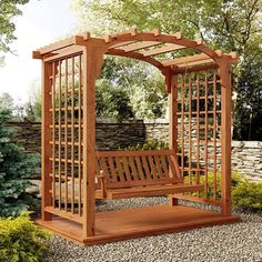 a wooden bench sitting in the middle of a garden