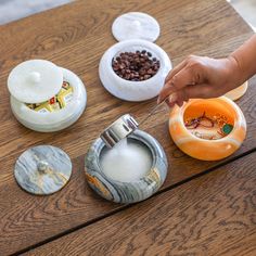 a person is cutting into some rings on a table with other items in the background