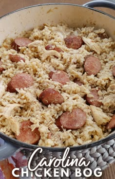 a close up of a pan of food with rice and sausage on the side,