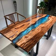 a table that is made out of wood and has blue water on it in the center