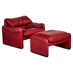 a red leather chair and footstool sitting next to each other