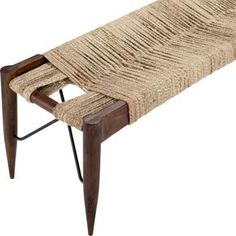 a bench made out of woven material with wooden legs