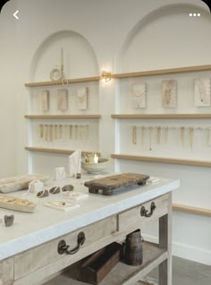 a white table topped with lots of shelves filled with items