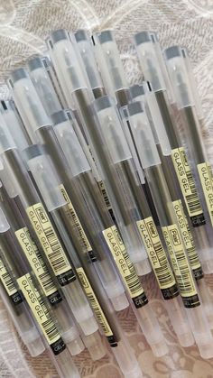 a group of pens sitting on top of a table next to each other in plastic containers