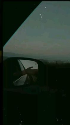 an airplane is seen through the window of another plane as it flies in the sky