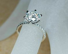 a diamond ring on top of a white piece of paper