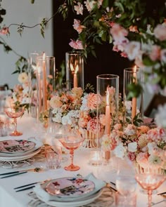 the table is set with flowers and candles